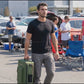BOLOTOR cooler backpack being carried into a tailgate, all-in-one cooler backpack with tarp shelter for outdoor tailgating and camping